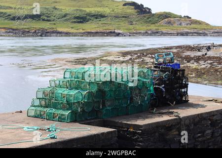 Lobster and crab pots and creels stacked up in a harbour Stock Photo