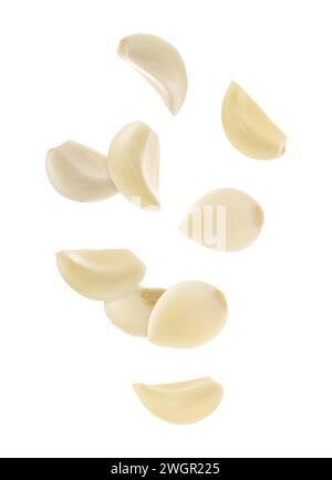 Fresh garlic cloves falling on white background Stock Photo