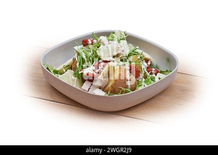 Bowl with hot patatoes, salad and caesar on white and wood Stock Photo