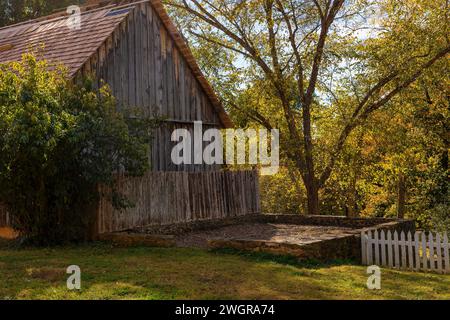 An inviting bench sits in front of the side yard Stock Photo