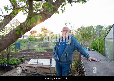 Portrait of Elderly man standing in his allotment in the early morning Stock Photo