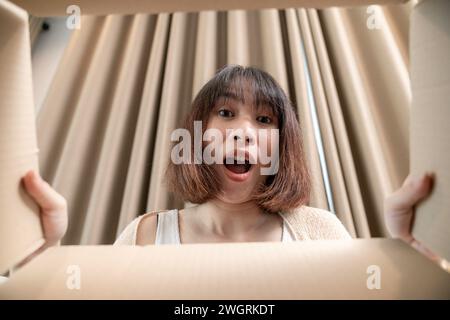 Excited young woman with items she ordered Stock Photo