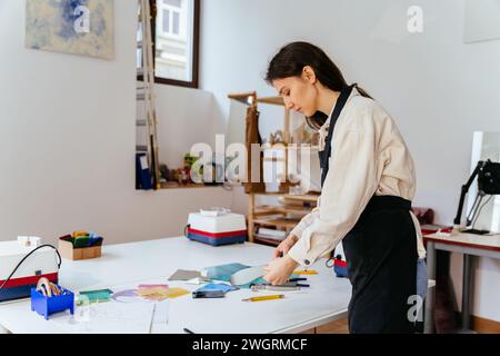 Young female stained glass artists working in studio. Stained glass art, glass work process. Art creative, handmade, Hobbies and crafts concept. Stock Photo