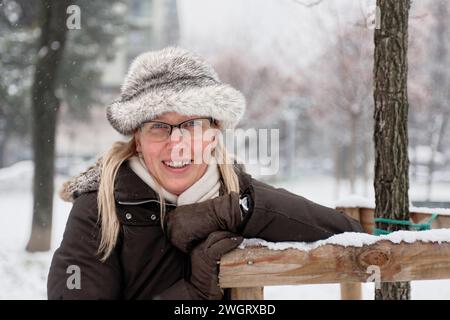 Woman under a snowfall, Milano, Italy Stock Photo