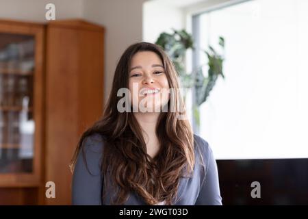 young woman standing at home Stock Photo