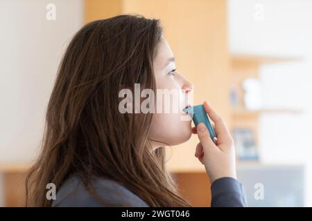 young woman using an inhaler Stock Photo