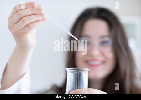 scientist young woman working in a labor with lab glasses Stock Photo