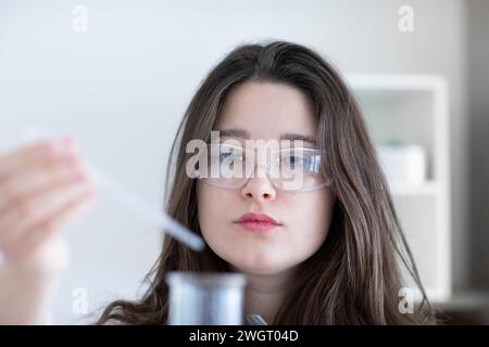 scientist young woman working in a labor with lab glasses Stock Photo