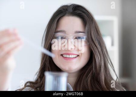 scientist young woman working in a labor with lab glasses Stock Photo