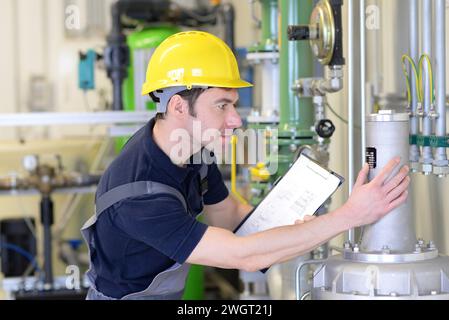 industrial worker repairs machines and equipment in a refinery Stock Photo