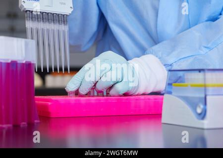Tools and containers in a medical lab, work being done with pipette and samples Stock Photo