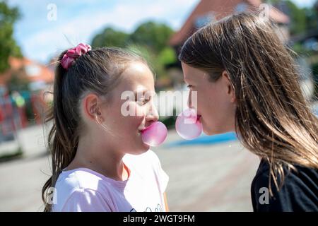 Young group of girl with bubble gum, blowing bubbles Stock Photo
