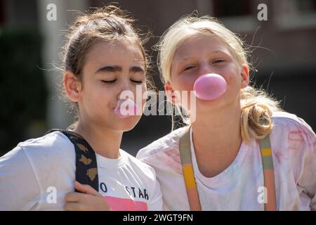 Young girl with bubble gum, blowing bubbles Stock Photo