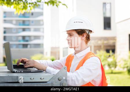 Engineer with helmet working outside new building Stock Photo