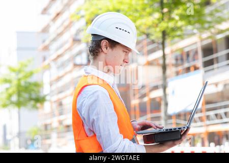 Engineer with helmet working outside new building Stock Photo