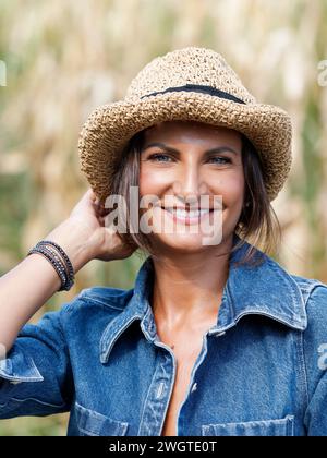 Positive young woman looking for jeans pantaloons during shopping in ...