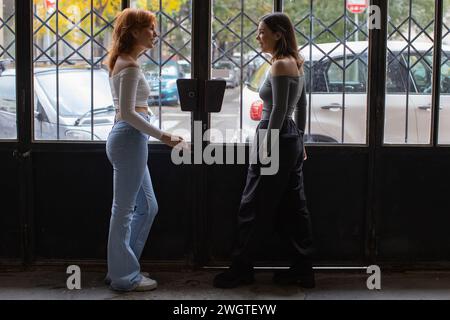 two girlfriends talking to each other in the porch Stock Photo