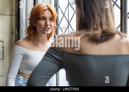 two girlfriends having a secret conversation Stock Photo
