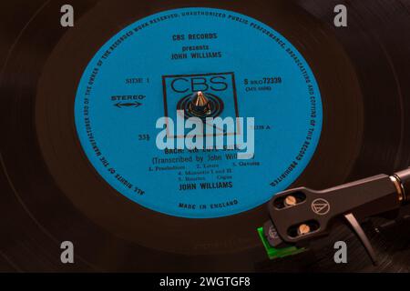 CBS Records presents John Williams vinyl record album LP with tonearm, cartridge, headshell and stylus on turntable record player - 1964 Stock Photo