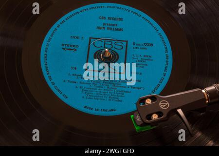 CBS Records presents John Williams vinyl record album LP with tonearm, cartridge, headshell and stylus on turntable record player - 1964 Stock Photo