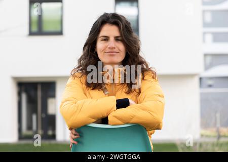young woman on a chair outside her home Stock Photo