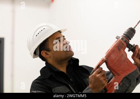 Engineer with helmet, portrait with a drill Stock Photo