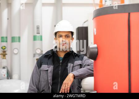 Engineer with helmet, portrait in a heating room Stock Photo