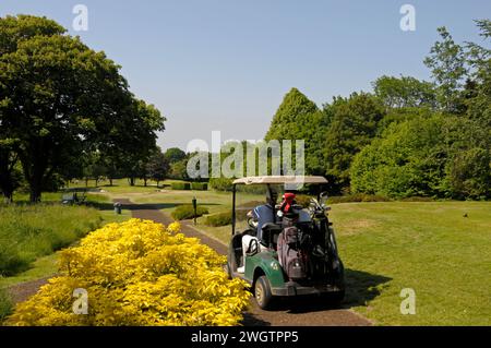 View from 8th Tee with Golfer in a buggy heading towards Green, Woodcote Park Golf Club, Coulsdon, Surrey, England Stock Photo