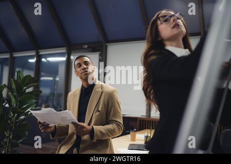 Excited diverse employees team celebrating teamwork success. Stock Photo