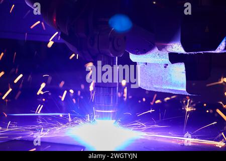 Robotic Arm Welding in Industrial Setting with Dynamic Sparks Stock Photo