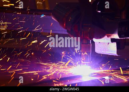 CNC Plasma Cutting Machine and Sparks in Metal Fabrication Shop Stock Photo