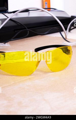 Engraver and yellow protection glasses on the desktop close up Stock Photo
