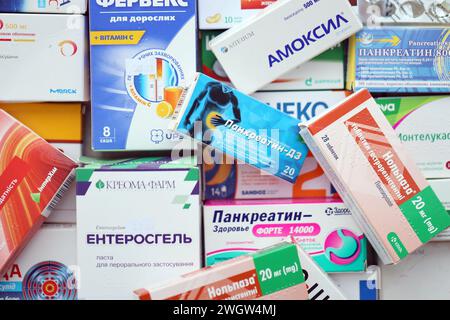 KYIV, UKRAINE - NOVEMBER 27, 2023 Many boxes of pills and capsules stacked in pharmacy drug store close up Stock Photo