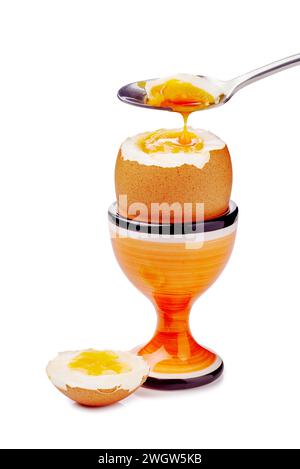 Soft-boiled egg in cup with spoon isolated on white Stock Photo