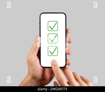 Online poll, survey, test on mobile phone screen. Passing questionnaire, research with checkboxes, checkmarks, check list Stock Photo