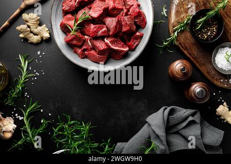 Beef meat entrecote sliced, raw beef meat fillet on black background, top view Stock Photo