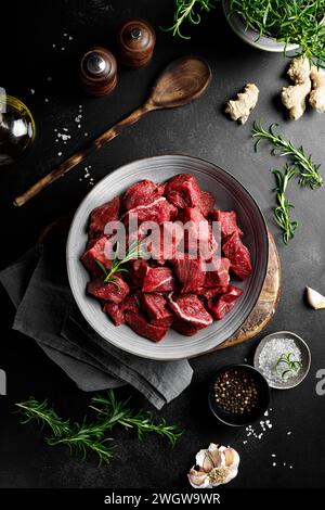 Beef meat entrecote sliced, raw beef meat fillet on black background, top view Stock Photo