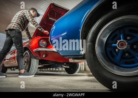 Caucasian American Classic Cars Enthusiast in His 30s Working on His Vehicle Stock Photo