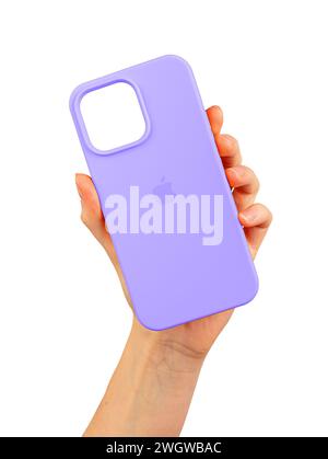 Berlin Germany December 21 2023 Violet phone case in hand. Silicon phonecase, protector isolated on white Stock Photo