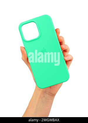 Berlin Germany December 21 2023 Green phone case in hand. Silicone protector isolated on white Stock Photo