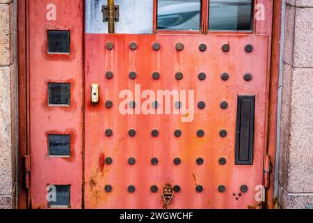 An unusual red dotted metal door on a building in Helsinki, Finland Stock Photo