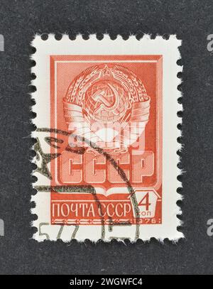 Cancelled postage stamp printed by Soviet Union, that shows State Coat of Arms of USSR, circa 1976. Stock Photo