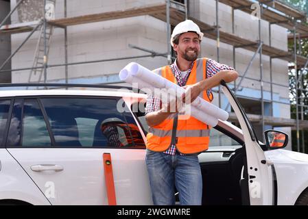 portrait smiling  construction manager / architect on site during the construction of a house - planning and control on site Stock Photo
