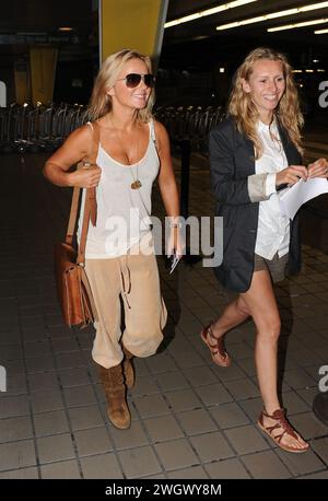 MIAMI, FL - SEPTEMBER 09: Spice Girl Geri Halliwell (L) arrives at Miami International Airport on holiday. After her recent bikini malfunction, you'd have thought that Geri Halliwell may now be a bit more careful her wardrobe choices. But her ample cleavage was on display once again today as she inadvertently showed off more than was probably necessary. The 38-year-old was dressed very strangely in a, peach-coloured velour tracksuit bottoms and brown suede boots.he clutched what looked like a brown school satchel and hid her eyes behind aviator sunglasses. Geraldine Estelle 'Geri' Halliwell Stock Photo