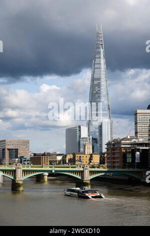 London, UK - July 28, 2023; River Thames in London with Southwark Bridge and The Shard and Uber boat Stock Photo