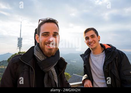 Wide angle close-up view of two engineers at a power plant smiling at the camera Stock Photo