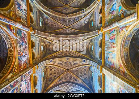 CREMONA, ITALY - APRIL 6, 2022: The richly decorated rib-vaulted ceiling of medieval masterpiece Santa Maria Assunta Cathedral with ornaments, carving Stock Photo