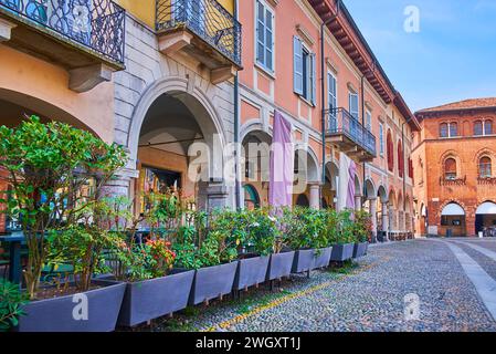 Historic houses with arcades, small cafes, restaurants and shops on Piazza della Vittoria, Lodi, Italy Stock Photo