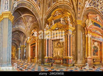 CREMONA, ITALY - APRIL 6, 2022: Panorama with the richly decorated side chapels with altars of St Fermo, St Eusebius and St Catherine in Cathedral of Stock Photo