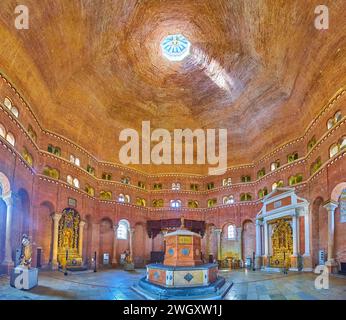 CREMONA, ITALY - APRIL 6, 2022: The medieval hall of Cremona Baptistery with sculptured baptismal font and richly decorated altars in background, Ital Stock Photo